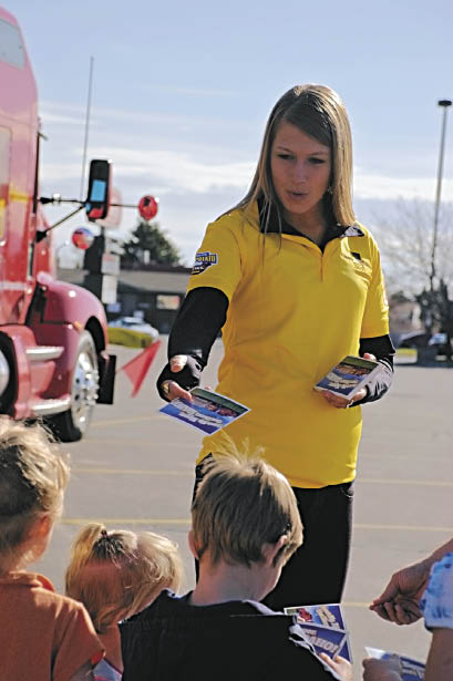 Kaiti Frickley handing out a postcard to children in Idaho Falls, Idaho